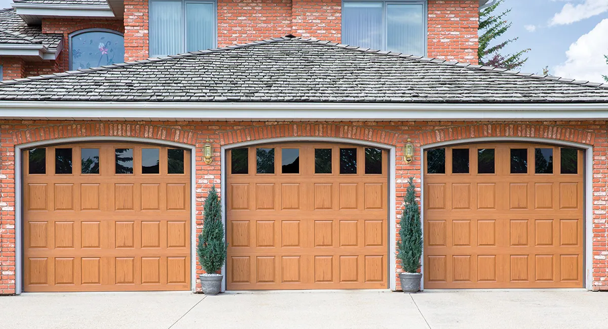 three natural oak fiberglass garage doors with eighteen vertical windows