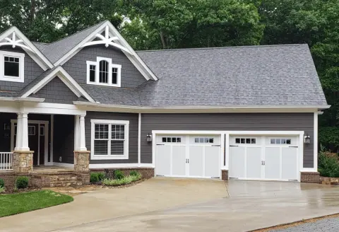 Aristocrat Presidential Series doors on a three-car craftsman garage