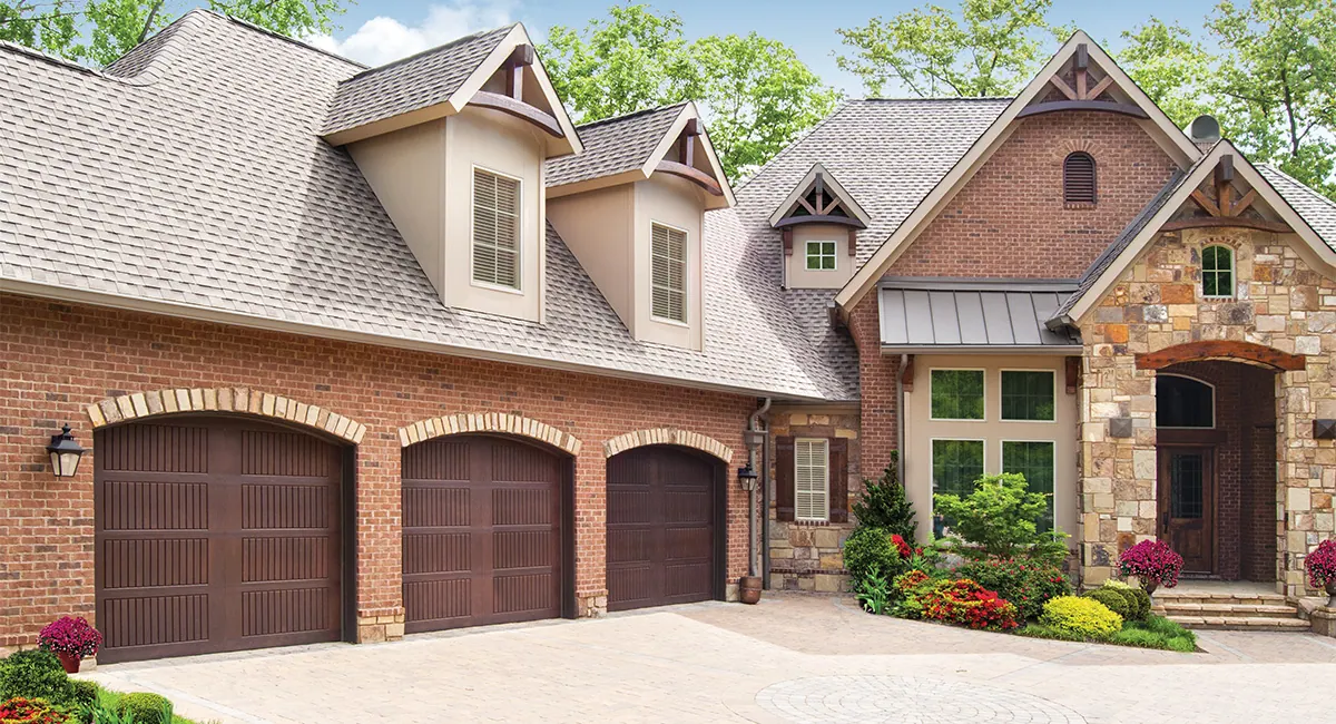three walnut fiberglass garage doors