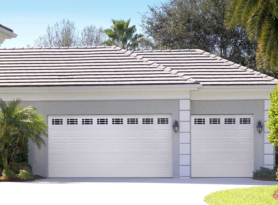 Traditional raised panel garage door — white steel with windows